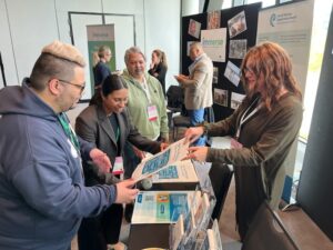 Informal group of people discussing a poster handout.