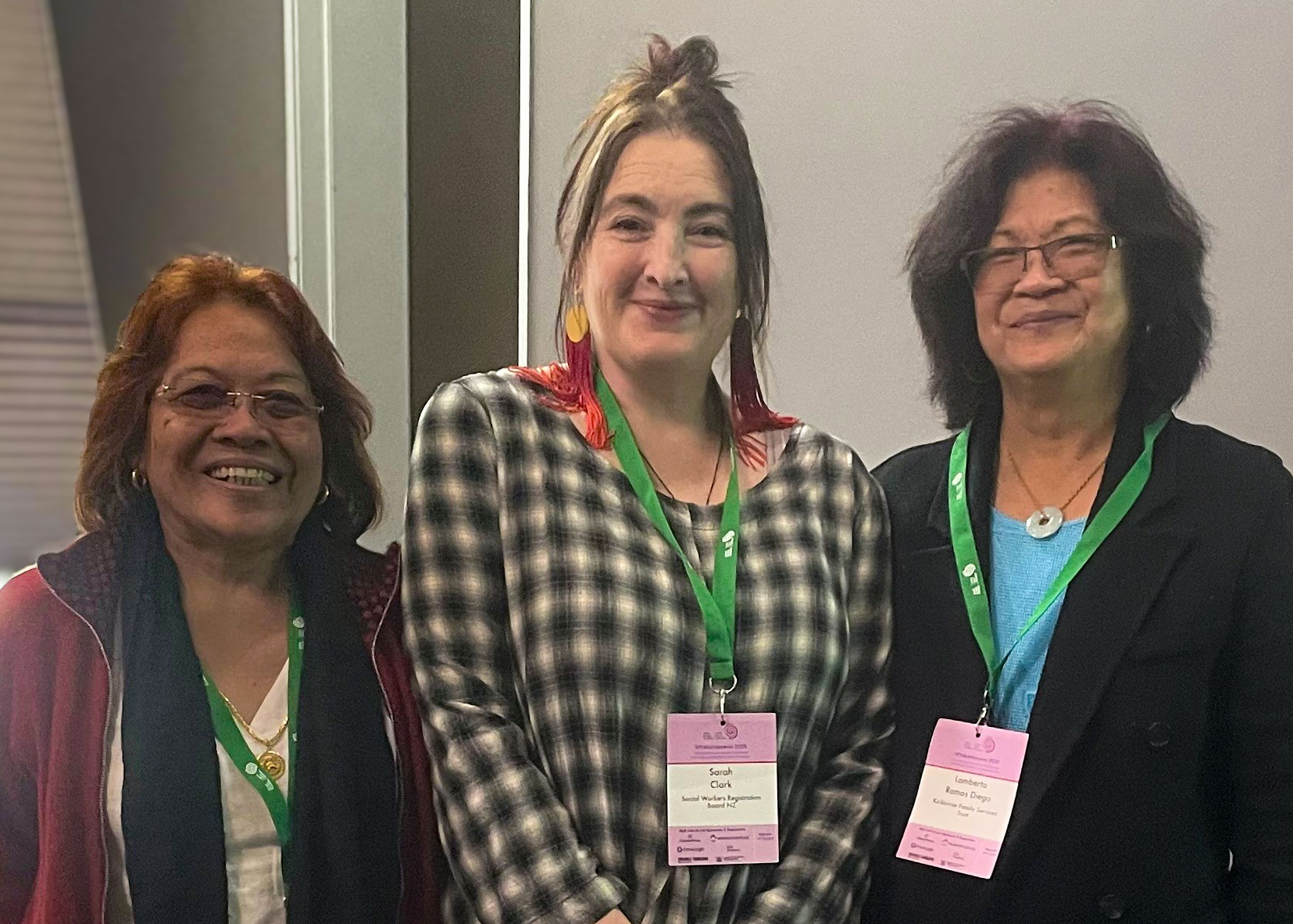 Sarah Clark stands smiling with Merlyn Espejo and Lamberta Ramos Diego of the Kirikiriroa Family Services Trust.